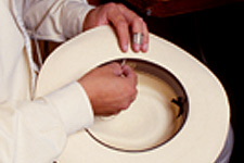 Sewing a sweatband into a Panama hat